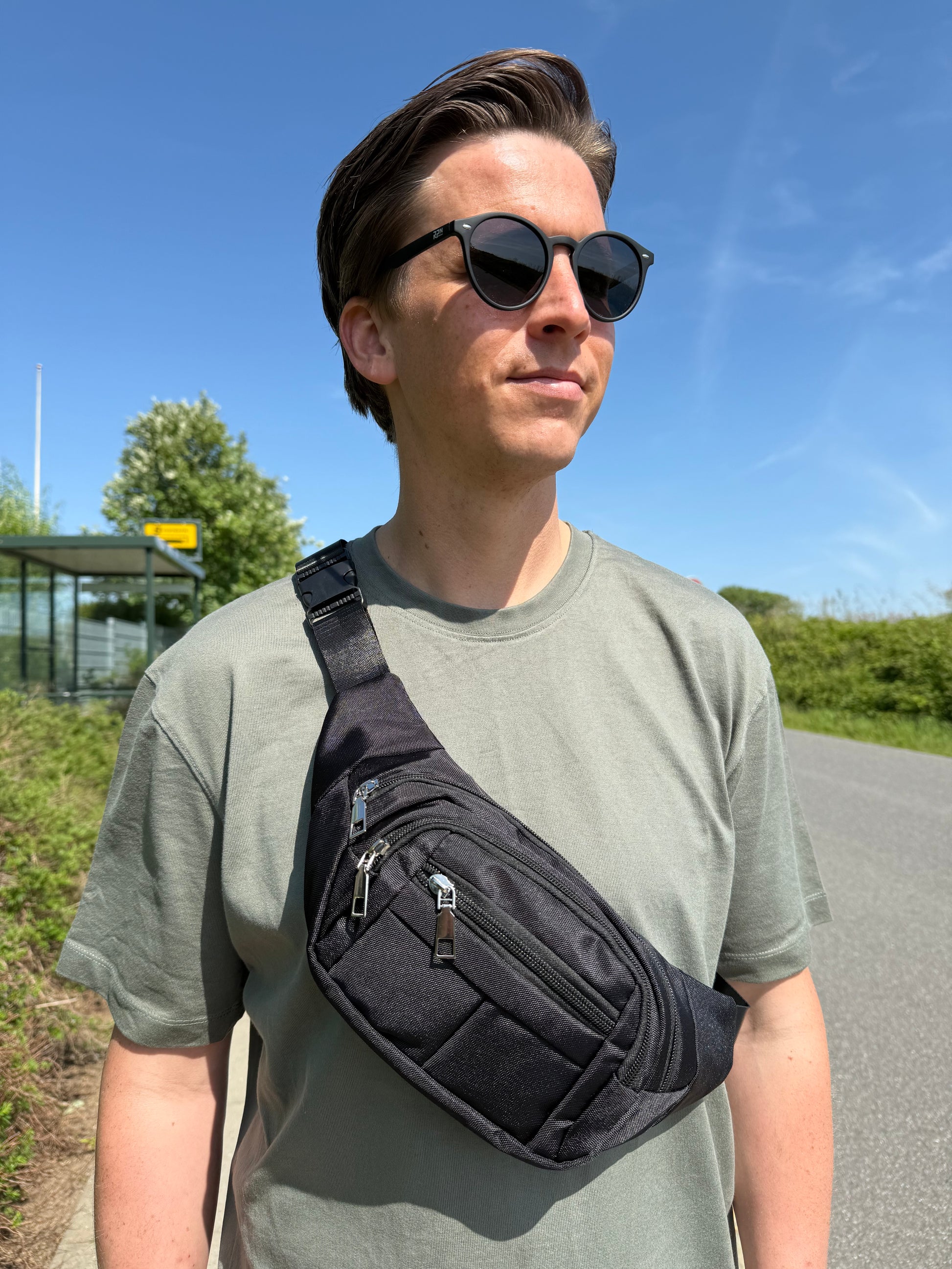 Mandlig model med MS bæltetaske i sort båret som crossbody foran.
